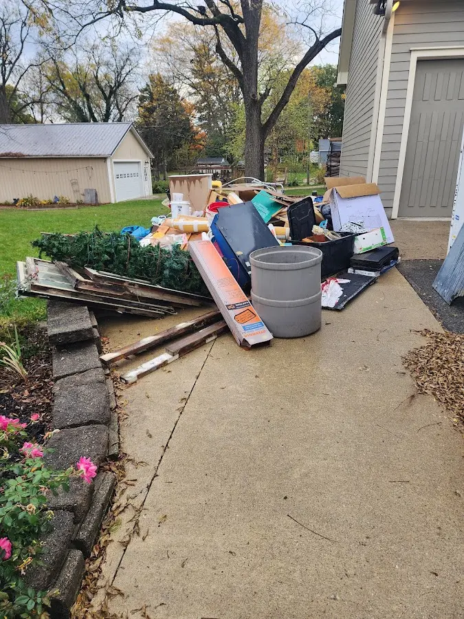 Dumpster being loaded with debris for Roofing Dumpster Rental in Louisburg